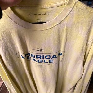 Used long sleeve American Eagle shirt. Colors are yellow white and a blue logo.